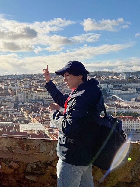 Tourist with guide overlooking Lisbon from São Jorge Castle viewing area.