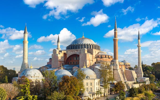 Hagia Sophia with minarets under a blue sky in Istanbul, Turkey.