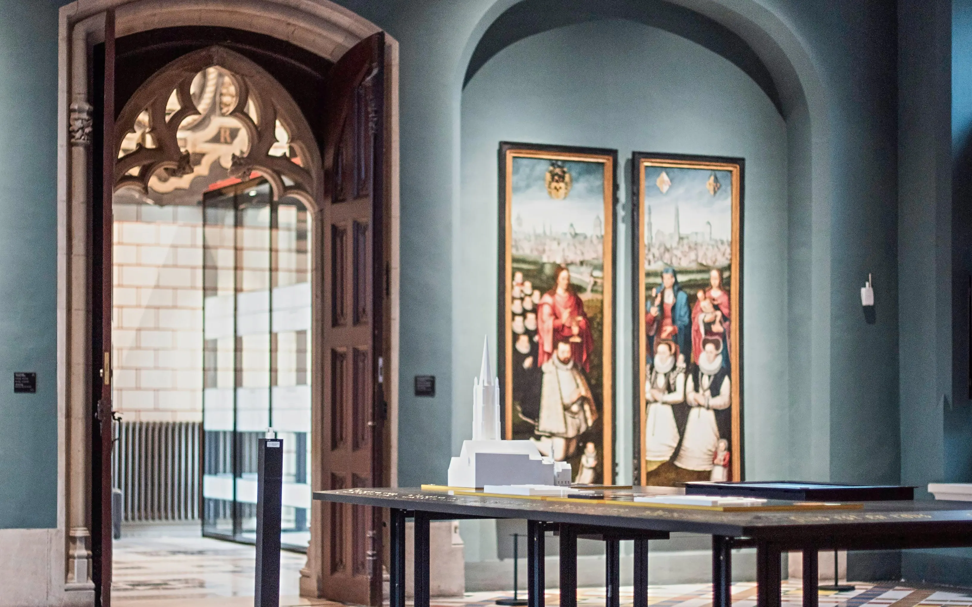 Gruuthusemuseum interior with historical paintings and architectural model.
