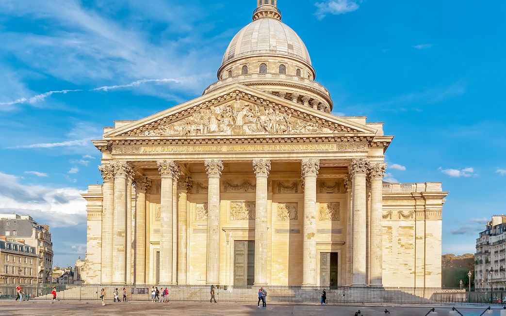 Pantheon entrance in Paris with tourists exploring the historic site.