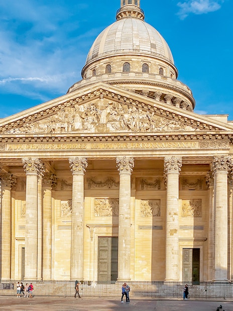 Pantheon entrance in Paris with tourists exploring the historic site.