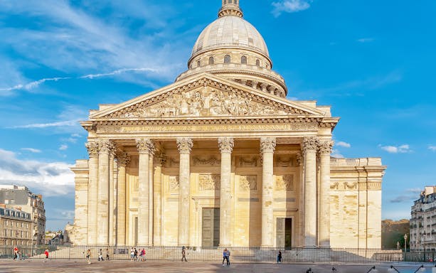 Pantheon entrance in Paris with tourists exploring the historic site.