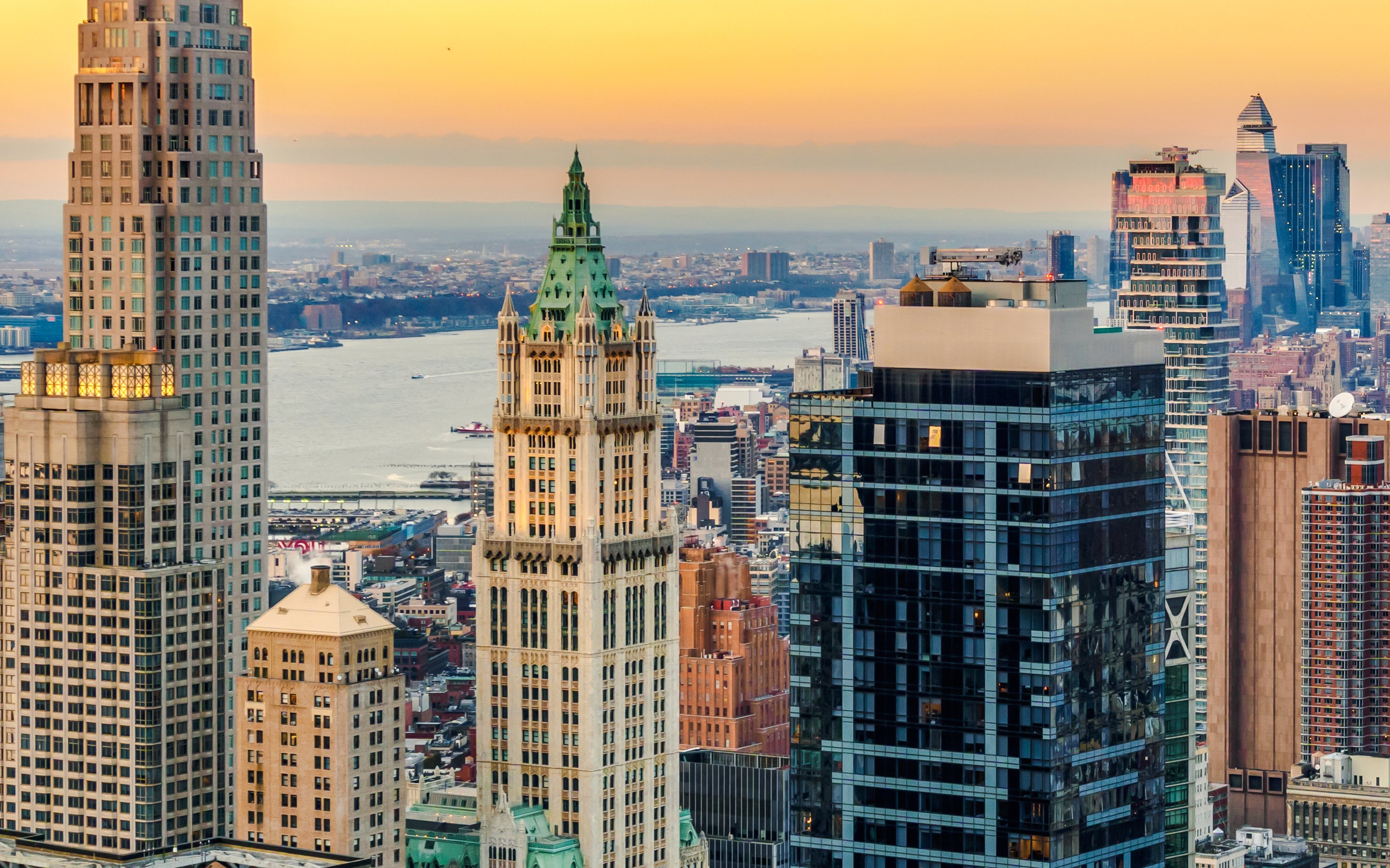 Woolworth Building in New York City skyline at sunset.