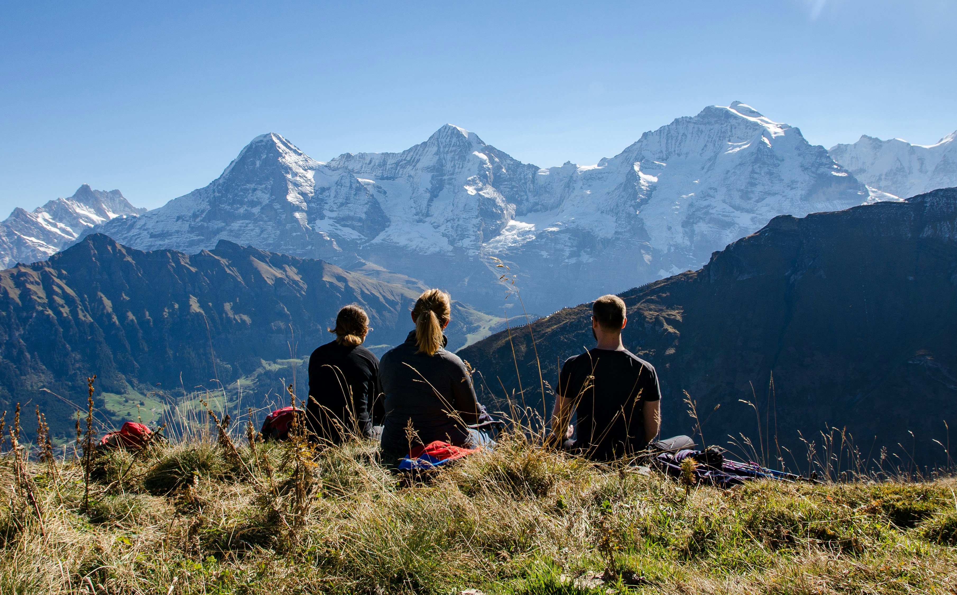Eiger, Mönch, and Jungfrau mountains in the Swiss Alps with a scenic view of snow-capped peaks.