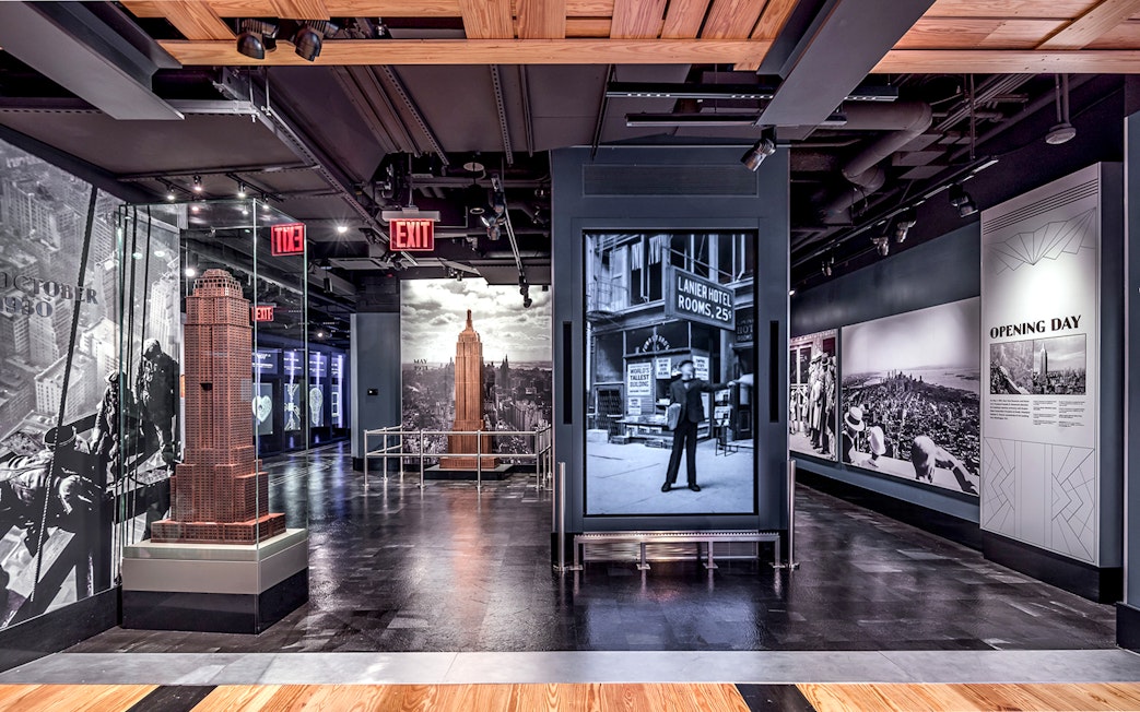 Empire State Building exhibit with historical photos and model in New York City.