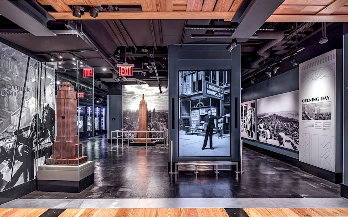 Empire State Building exhibit with historical photos and model in New York City.
