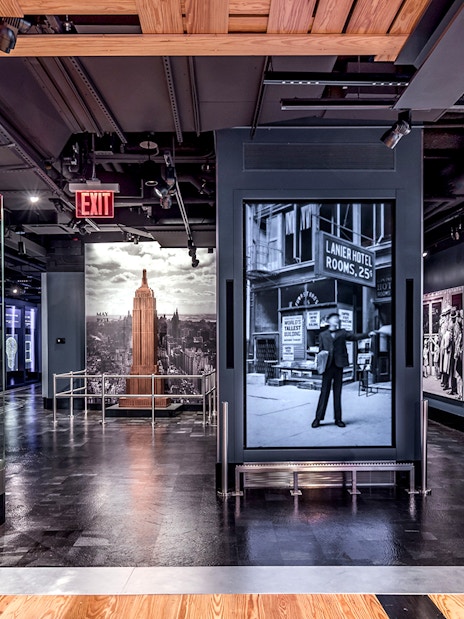 Empire State Building exhibit with historical photos and model in New York City.