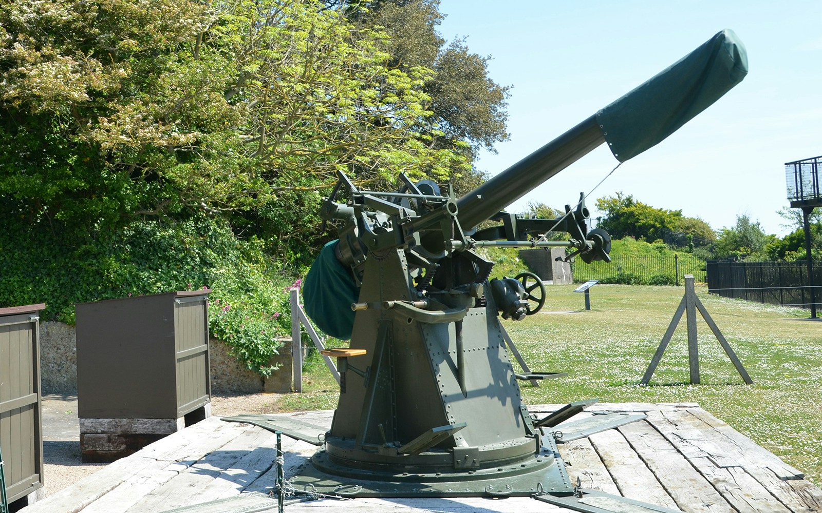 Anti-aircraft gun at Dover Castle's Secret Wartime Tunnels, surrounded by greenery.