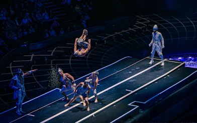 Acrobats performing mid-air flips at La Perle show in Dubai.