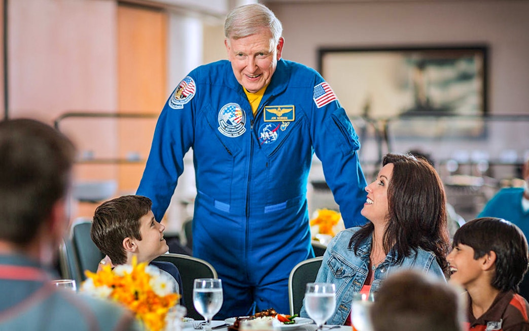 Astronaut interacting with visitors during lunch at Kennedy Space Center.