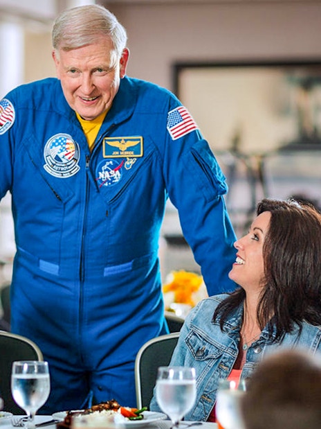 Astronaut interacting with visitors during lunch at Kennedy Space Center.