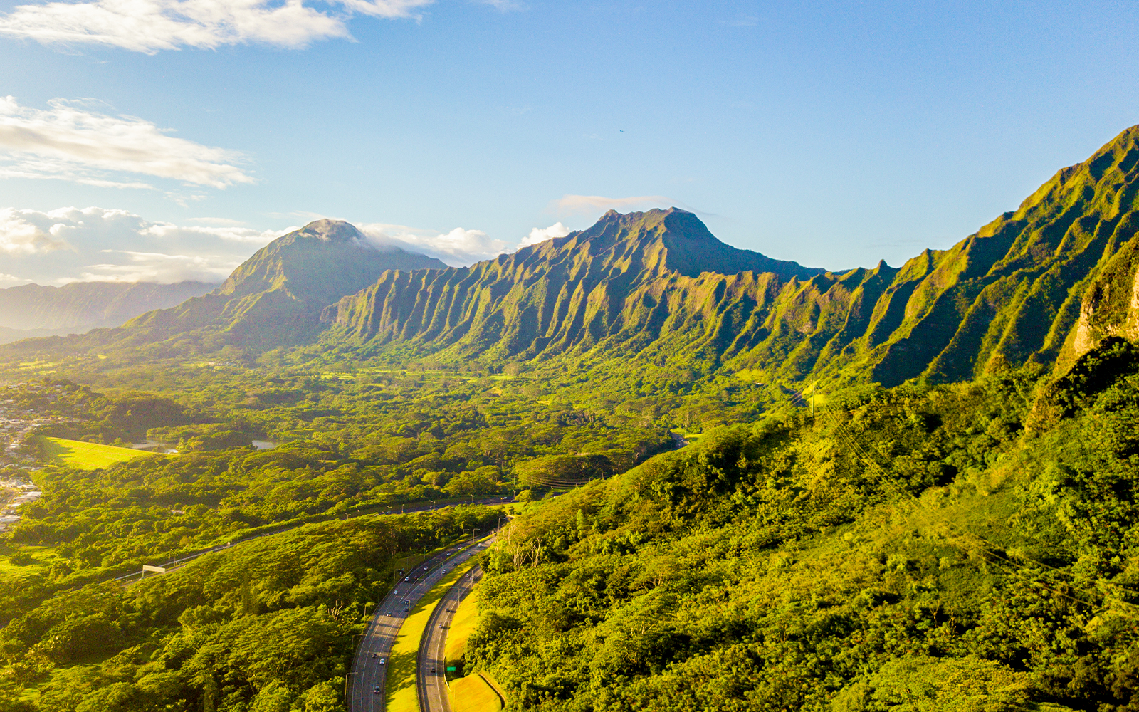 Green cliffs and mountains on the island of Oahu, Hawaii with the world famous Haiku stairs or the stairs to heaven - koolau volcano mountain ranges