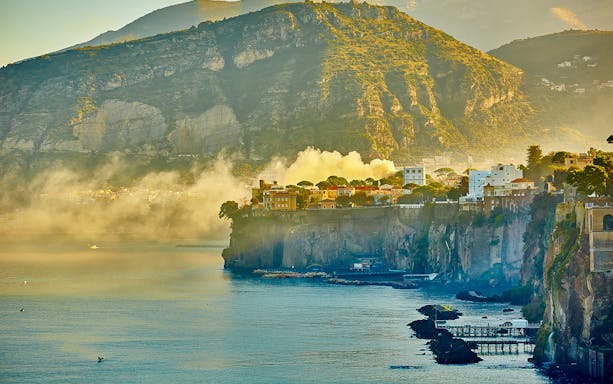 Sorrento coastline with cliffs and buildings during a guided tour.