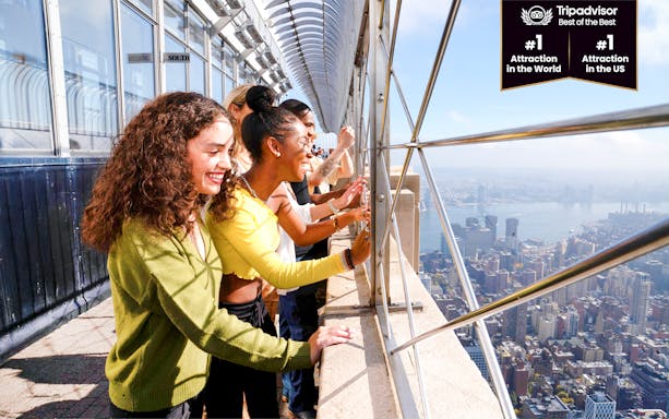 Visitors enjoying the view from the Empire State Building observation deck in New York City.
