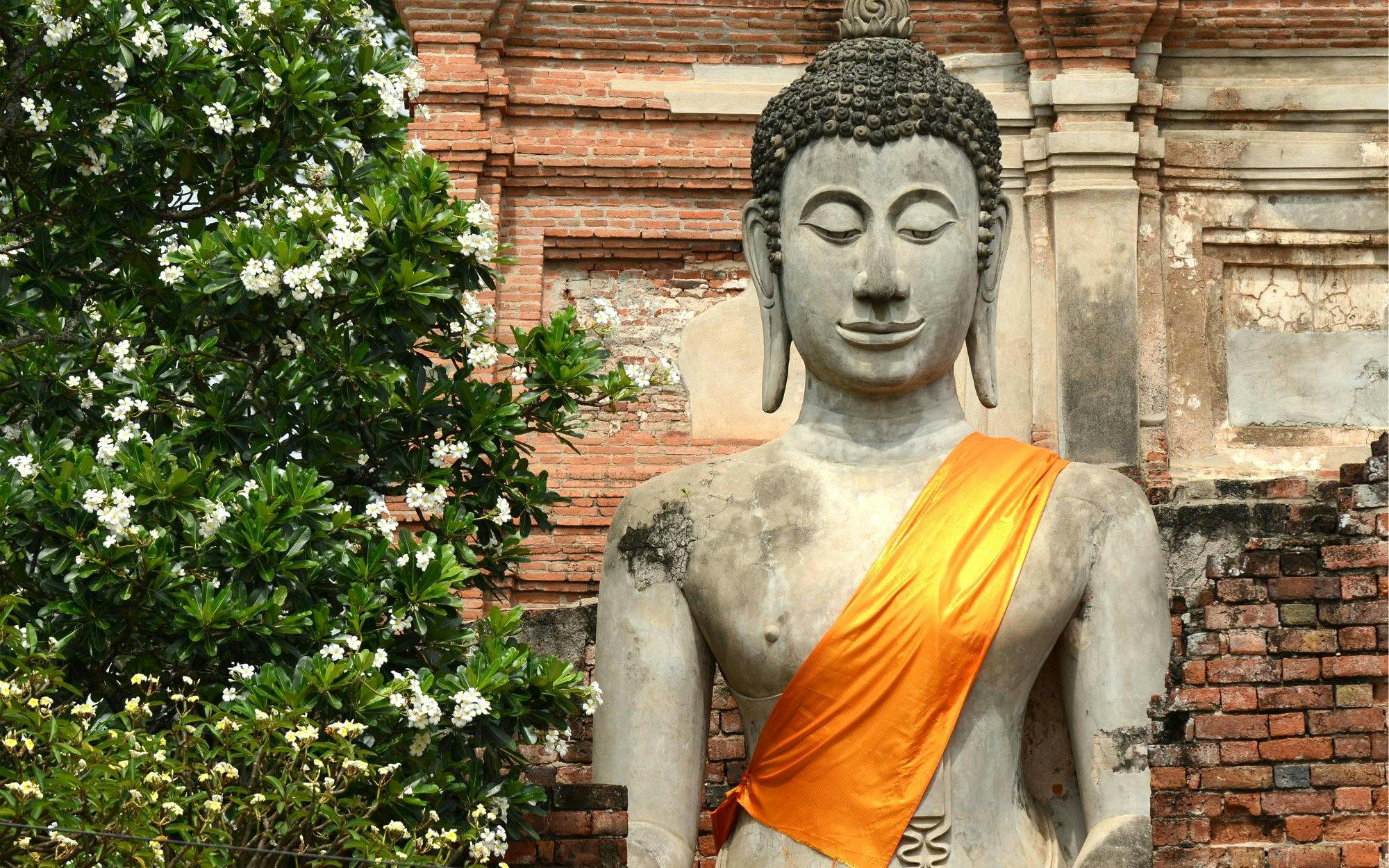 Buddha statue with orange robe at Ayutthaya Temples, Thailand.