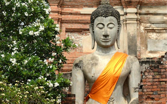 Buddha statue with orange robe at Ayutthaya Temples, Thailand.