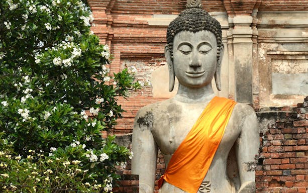 Buddha statue with orange robe at Ayutthaya Temples, Thailand.