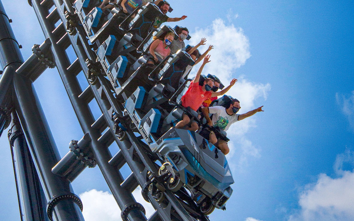 People riding Velocicoaster at Universal Orlando's Jurassic Park.