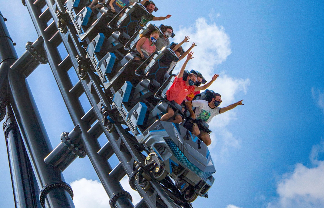 People riding Velocicoaster at Universal Orlando's Jurassic Park.