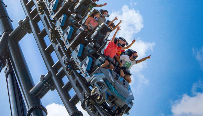 People riding Velocicoaster at Universal Orlando's Jurassic Park.