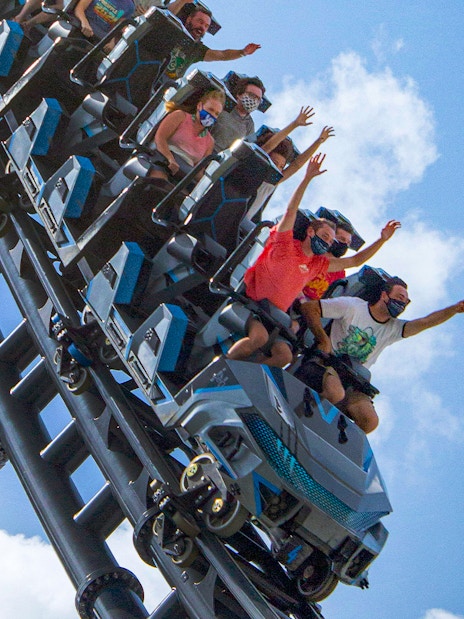 People riding Velocicoaster at Universal Orlando's Jurassic Park.