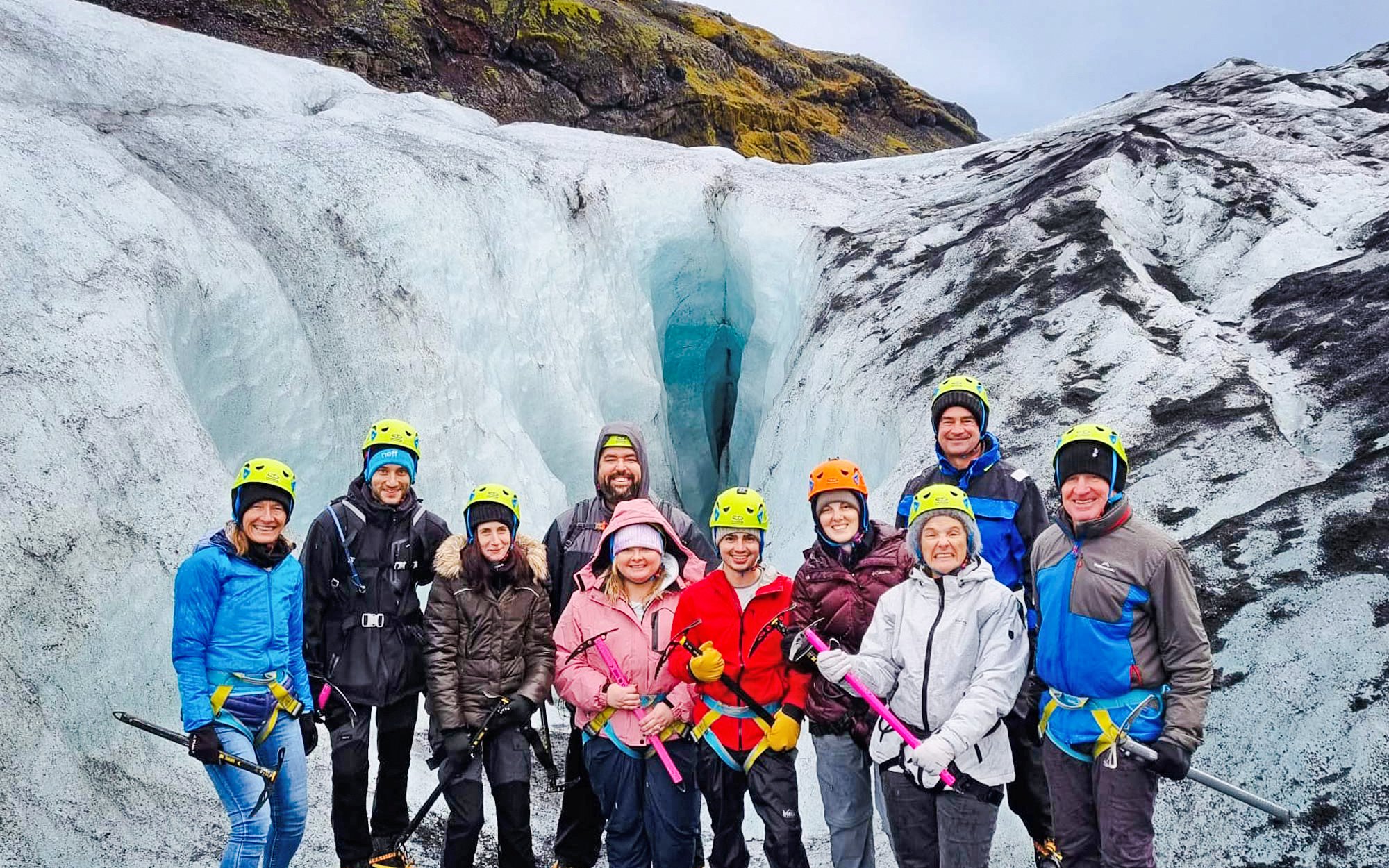 Tourists with helmets and ice axes at Sólheimajökull glacier, Reykjavik.