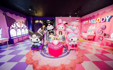 Family enjoying My Melody section at Ocean Park with colorful character displays.