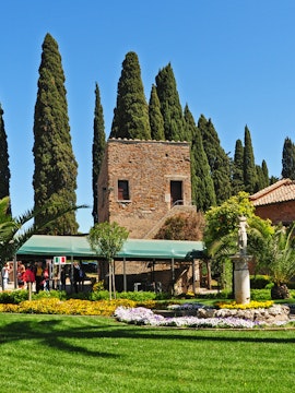 Catacombe di San Callisto entrance with stone building and garden in Rome.