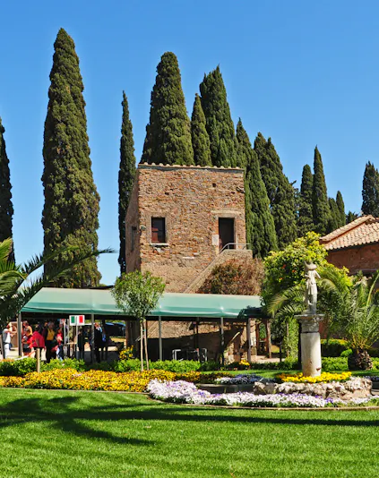 Catacombe di San Callisto entrance with stone building and garden in Rome.