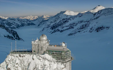 Jungfraujoch observatory surrounded by snow-capped Alps, view from Interlaken East.