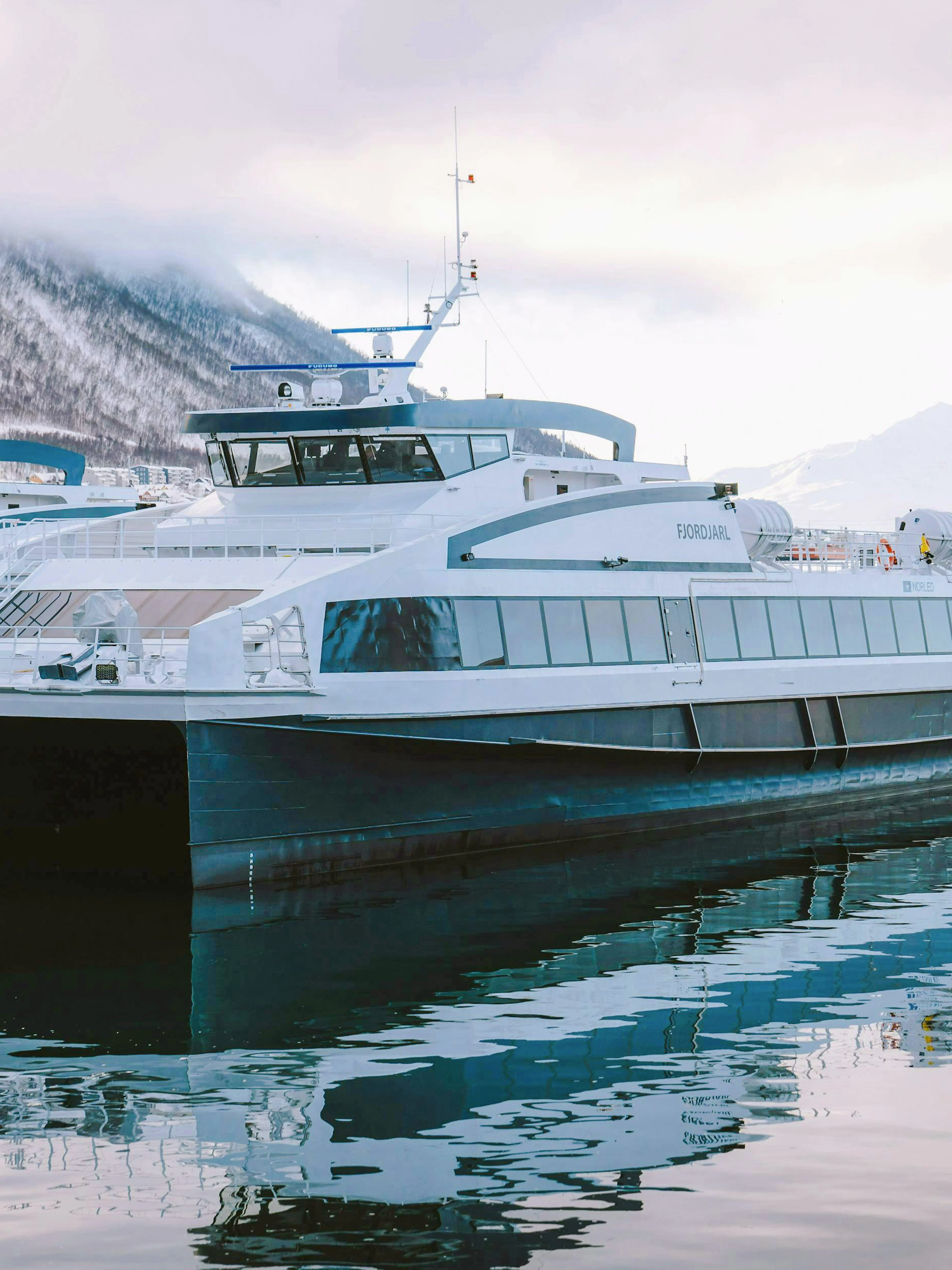 Fast boat docked in Tromsø for whale watching tour.