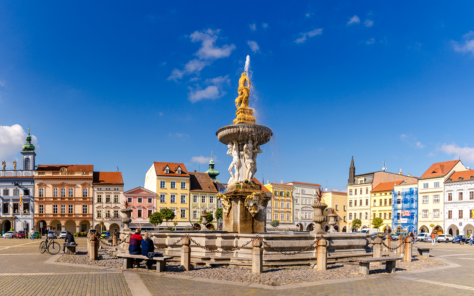 Samson Fountain in Ceske Budejovice town square with colorful historic buildings.