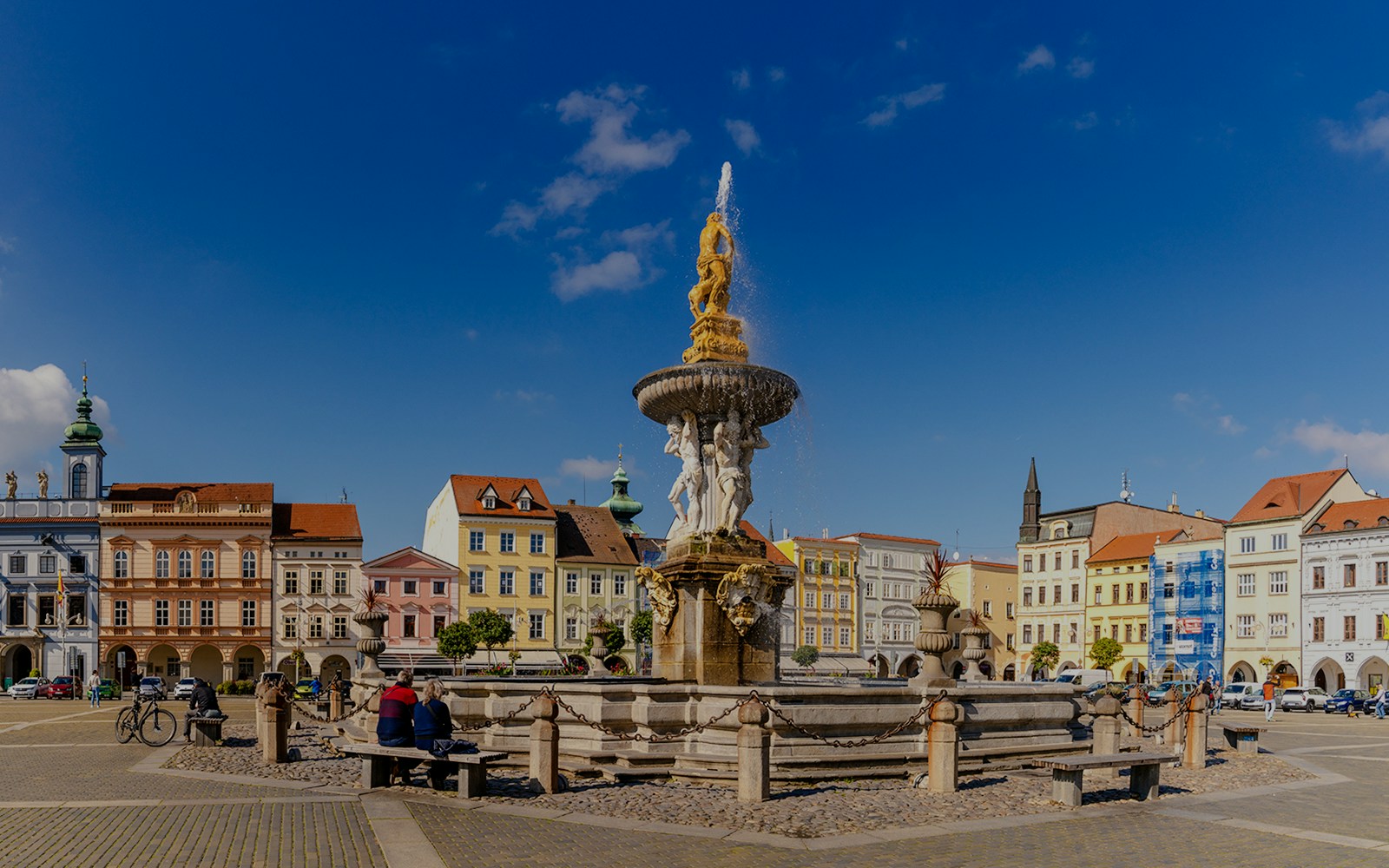 Samson Fountain in Ceske Budejovice town square with colorful historic buildings.