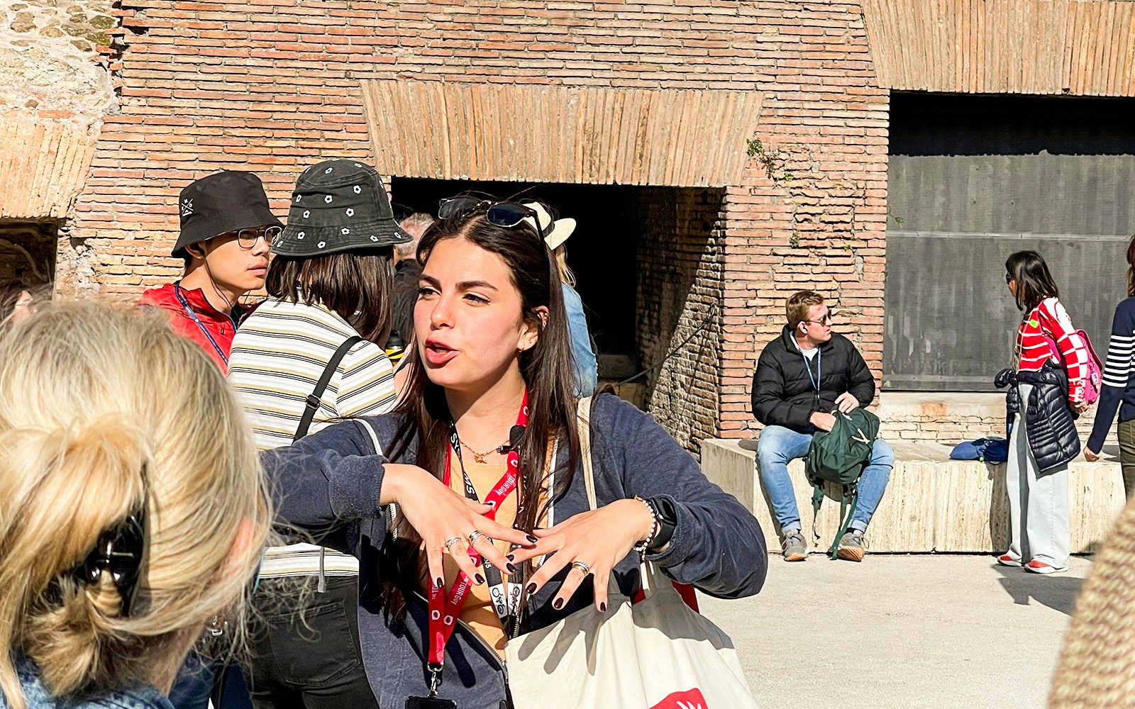 Roman Colosseum exterior with tourists exploring ancient architecture in Rome, Italy.