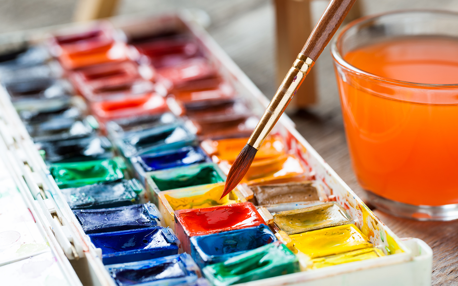 Set of watercolor paints and paintbrushes for painting closeup.