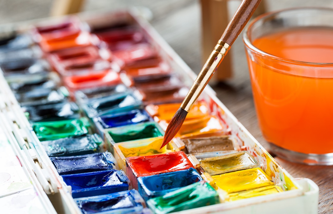 Set of watercolor paints and paintbrushes for painting closeup.