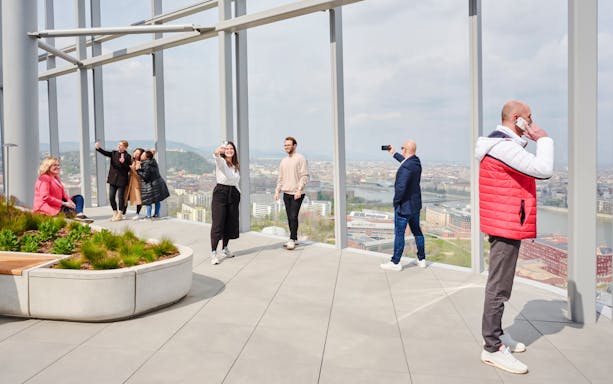Visitors enjoying the view from SkyDeck at MOL Campus, Budapest.