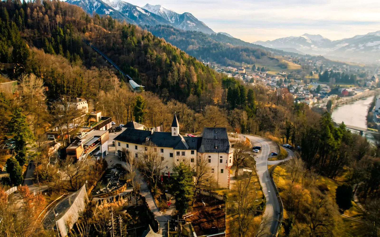 Aerial view of Alpenzoo Innsbruck surrounded by mountains and forest.