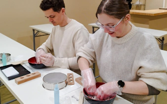 Participants making traditional Japanese sweets during a tea ceremony in Kyoto's Karasuma area.