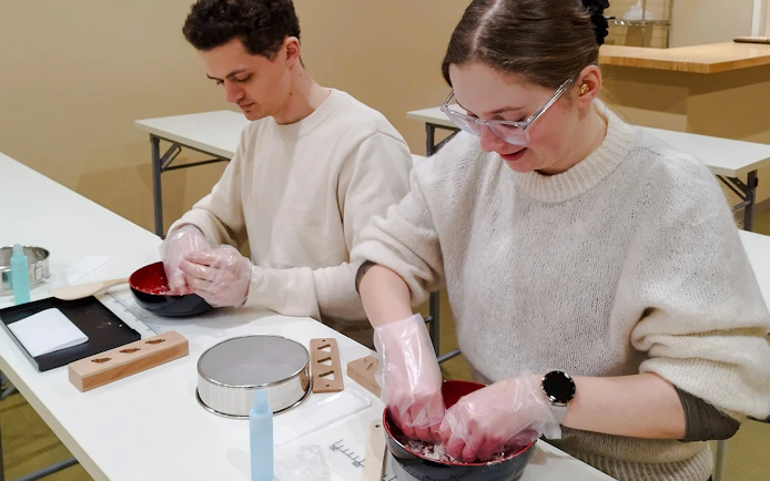 Participants making traditional Japanese sweets during a tea ceremony in Kyoto's Karasuma area.