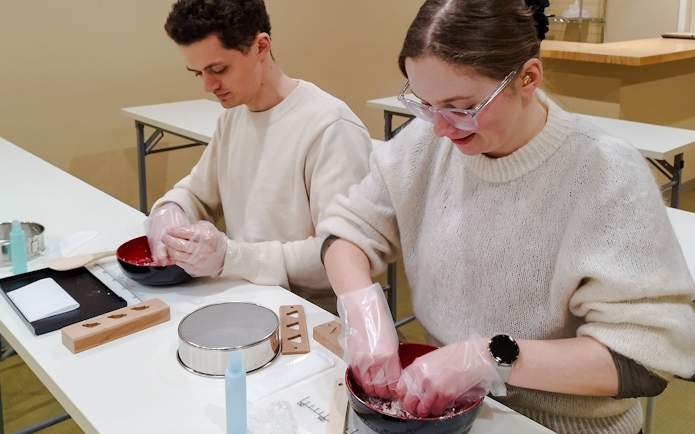 Participants making traditional Japanese sweets during a tea ceremony in Kyoto's Karasuma area.