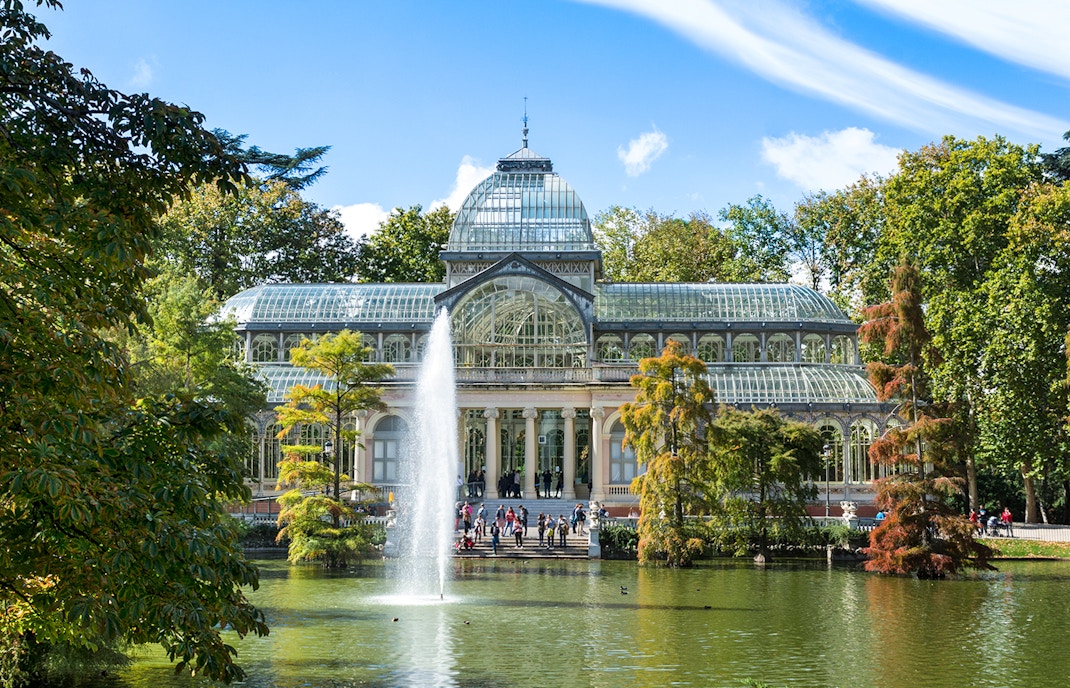 Palacio de Cristal in Madrid's Retiro Park with glass and iron architecture.