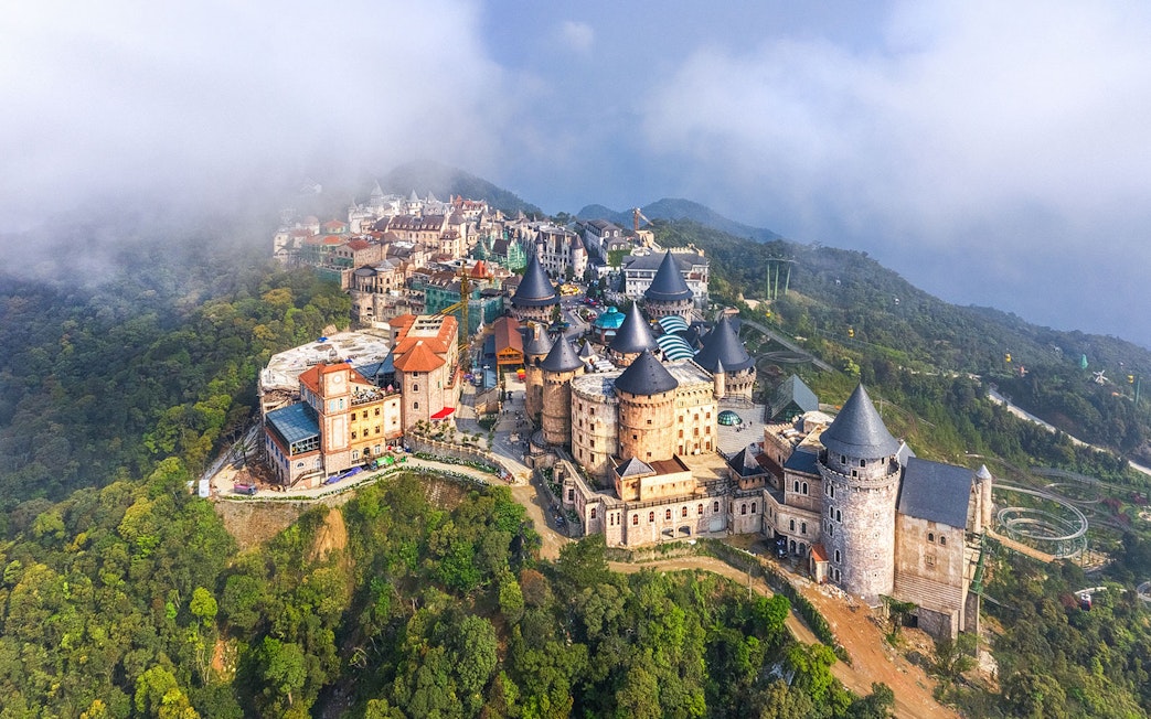 Aerial view of castles on Bana Hills shrouded in fog, Da Nang, Vietnam.