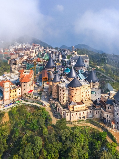 Aerial view of castles on Bana Hills shrouded in fog, Da Nang, Vietnam.