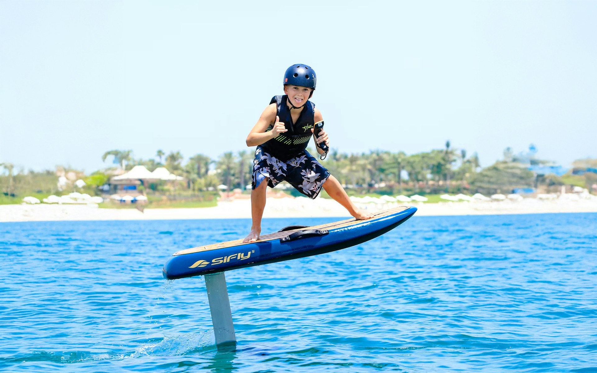 Kid efoil surfing on blue water in Dubai.
