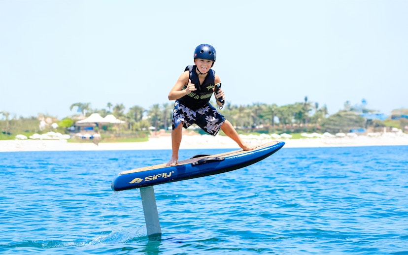 Kid efoil surfing on blue water in Dubai.