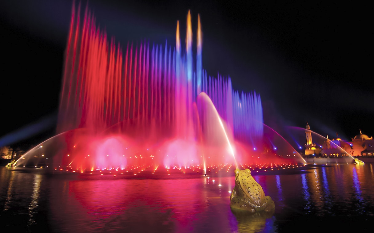Colorful water fountains at night in Efteling Theme Park, Netherlands.