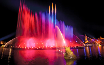 Colorful water fountains at night in Efteling Theme Park, Netherlands.