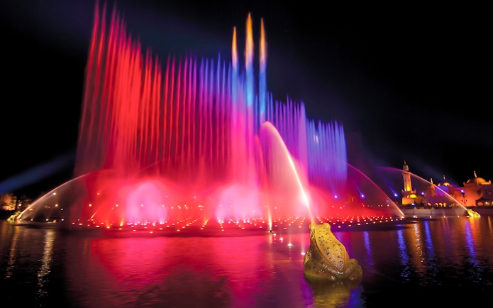 Colorful water fountains at night in Efteling Theme Park, Netherlands.