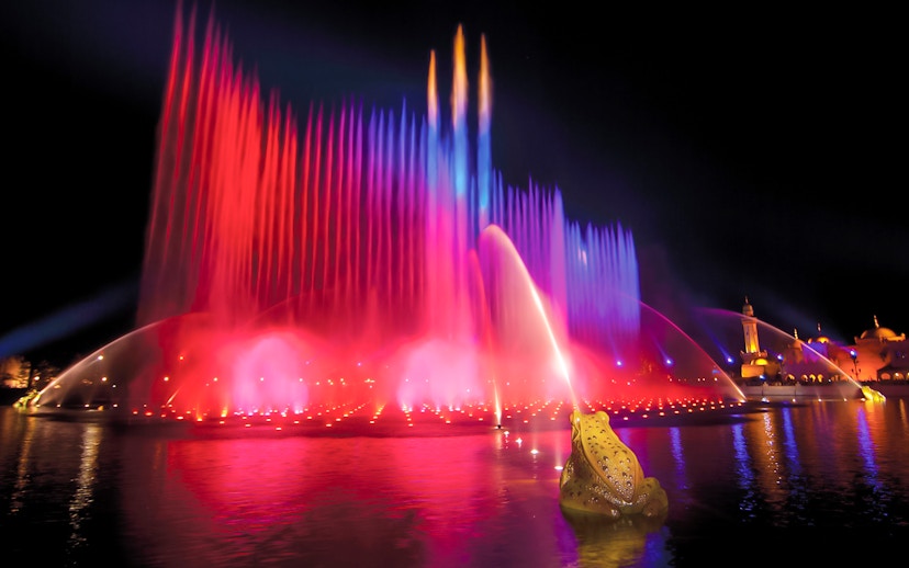 Colorful water fountains at night in Efteling Theme Park, Netherlands.